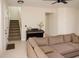 Spacious living room with a grand staircase, piano, and a comfortable sectional sofa at 900 S Maple Ave, Sanford, FL 32771