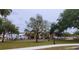 Community playground with play equipment, surrounded by mature trees and green space, perfect for families at 900 S Maple Ave, Sanford, FL 32771