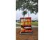 Utility box adorned with a sunset sailboat mural adding an artistic touch to the community landscape at 900 S Maple Ave, Sanford, FL 32771