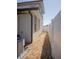 A narrow side yard, featuring rocks and a white vinyl fence at 900 S Maple Ave, Sanford, FL 32771