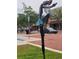 View of a tall metal sculpture art piece on the sidewalk near the brick-paved street in Sanford Florida at 900 S Maple Ave, Sanford, FL 32771