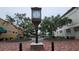 View of a large decorative street clock and brick paved open park area surrounded by various stores and buildings at 900 S Maple Ave, Sanford, FL 32771