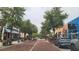 View of a brick street in a commercial district with shops and restaurants under a canopy of trees at 900 S Maple Ave, Sanford, FL 32771