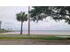 Scenic waterfront view with palm trees and mature trees, offering a glimpse of the tranquil waters at 900 S Maple Ave, Sanford, FL 32771