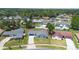 Aerial view of a single-Gathering home with a large front yard and mature trees in a residential neighborhood at 1148 Martin L King Dr, Orlando, FL 32805