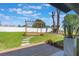 Landscaped backyard featuring a wooden pergola, a lush green lawn, and a privacy fence at 1148 Martin L King Dr, Orlando, FL 32805