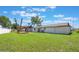 A spacious backyard featuring a lush green lawn and a charming wooden pergola at 1148 Martin L King Dr, Orlando, FL 32805