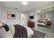 A bright bedroom featuring a large bed, stylish furniture, and modern artwork at 1148 Martin L King Dr, Orlando, FL 32805