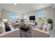 Spacious living room with bright windows, recessed lighting, and comfortable seating at 1148 Martin L King Dr, Orlando, FL 32805