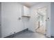 Storage room with white walls, overhead cabinets, and view into the kitchen at 1148 Martin L King Dr, Orlando, FL 32805