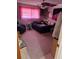 Bedroom featuring a bed, side chair, colorful window treatments, and carpeted floors at 116 E Palm Way, Edgewater, FL 32132