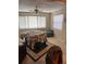 Bright dining room with a large table, chair, and multiple windows providing ample natural light at 116 E Palm Way, Edgewater, FL 32132