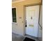 Traditional white front door with classic hardware and the house number displayed beside it at 116 E Palm Way, Edgewater, FL 32132