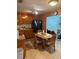 Traditional kitchen area featuring wood cabinets, dark appliances, a dining area, and plenty of natural light at 116 E Palm Way, Edgewater, FL 32132