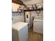 Functional laundry area featuring a modern washer, dryer, and water heater for convenience at 116 E Palm Way, Edgewater, FL 32132