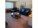 Inviting living room with a plush sofa, ottoman, coffee table, and window, creating a comfortable and stylish space at 116 E Palm Way, Edgewater, FL 32132