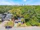 Aerial view of the home with surrounding trees, near the city with marked lot lines at 12 N Forest Ave, Orlando, FL 32803