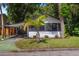 Cozy bungalow with carport and mature palm trees in a well-maintained yard at 12 N Forest Ave, Orlando, FL 32803