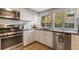 Functional kitchen featuring stainless steel appliances and bright natural light at 12 N Forest Ave, Orlando, FL 32803