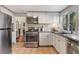 Well-equipped kitchen with stainless steel appliances and ample cabinet space at 12 N Forest Ave, Orlando, FL 32803