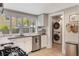 Bright kitchen featuring stainless steel appliances, white cabinetry, and a large window over the sink at 12 N Forest Ave, Orlando, FL 32803