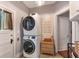 Convenient laundry room features stacked washer and dryer and decorative accents at 12 N Forest Ave, Orlando, FL 32803