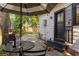 Outdoor patio with a table and a red wine bottle, perfect for relaxing and al fresco dining at 12 N Forest Ave, Orlando, FL 32803