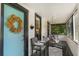 Charming front porch featuring a swing, a comfortable chair, and a colorful door at 12 N Forest Ave, Orlando, FL 32803