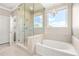 Elegant bathroom with separate shower and tub, complete with stylish fixtures at 12173 Aztec Rose Ln, Orlando, FL 32827