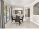 Bright dining area with elegant arches and sliding doors to the outdoor patio at 12173 Aztec Rose Ln, Orlando, FL 32827
