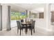 Bright dining area features a round table, backyard views through sliding glass doors, and neutral decor at 12173 Aztec Rose Ln, Orlando, FL 32827