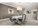 Modern dining room featuring a stylish chandelier and seating for six at 12173 Aztec Rose Ln, Orlando, FL 32827