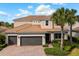 Beautiful two-story home featuring a three-car garage, well-kept landscaping, and a tile roof at 12173 Aztec Rose Ln, Orlando, FL 32827