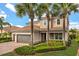 Charming two-story home features lush landscaping, a three-car garage and a tile roof at 12173 Aztec Rose Ln, Orlando, FL 32827