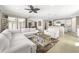 Open-concept living area featuring a large white couch, kitchen access, and natural lighting at 12173 Aztec Rose Ln, Orlando, FL 32827