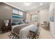 Calm main bedroom with neutral tones, a plush bed, and sunny window at 12173 Aztec Rose Ln, Orlando, FL 32827