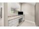 Functional office nook with granite countertops, white cabinetry, and built-in drawers at 12173 Aztec Rose Ln, Orlando, FL 32827
