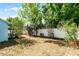 Fenced backyard with a lush green lawn and mature trees, offering privacy at 13234 Moonflower Ct, Clermont, FL 34711