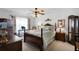Bedroom with a ceiling fan, window with curtain, a bed and nightstands with lamps at 13234 Moonflower Ct, Clermont, FL 34711