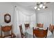 Cozy dining room with a round table, decorative curtains, a ceiling fan, and wood chairs at 13234 Moonflower Ct, Clermont, FL 34711