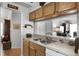 Eat-in kitchen area showcasing wooden cabinets, a double sink, and a view to an adjacent living space at 13234 Moonflower Ct, Clermont, FL 34711