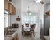 View of the kitchen into dining area with stainless steel refrigerator and tile floors at 13234 Moonflower Ct, Clermont, FL 34711