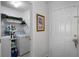 A laundry room with a washing machine, dryer, storage shelves, and laundry supplies at 13234 Moonflower Ct, Clermont, FL 34711
