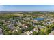 Aerial view of the property highlighting the community's golf course, ponds, and nearby lake at 13247 Hatherton Cir, Orlando, FL 32832