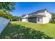 The expansive backyard features a white fence and views of the back of the house at 13247 Hatherton Cir, Orlando, FL 32832