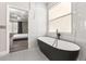 Modern bathroom with a black standalone tub and stylish marble wall tiles at 13247 Hatherton Cir, Orlando, FL 32832