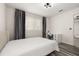 Bedroom with natural light, gray wood-look floors, neutral walls, and a desk at 13247 Hatherton Cir, Orlando, FL 32832