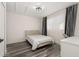 Bedroom featuring wood-look floors, neutral walls, and a natural light-filled window at 13247 Hatherton Cir, Orlando, FL 32832
