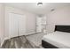 Bedroom featuring wood-look floors, neutral walls, closet, and door to hallway at 13247 Hatherton Cir, Orlando, FL 32832