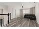A bonus room upstairs features a modern sofa and sleek laminate floors at 13247 Hatherton Cir, Orlando, FL 32832